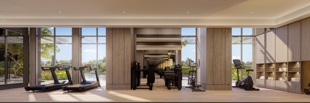 Indoor gymnasium with treadmills and strength equipment overlooking the pool at The Serra Residences, Novena